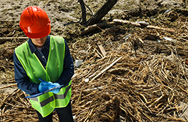 A man in a helmet investigates the pollution